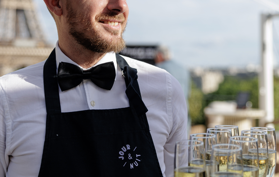 Serveur JOUR & NUIT servant le champagne au plateau lors du cocktail sur le rooftop